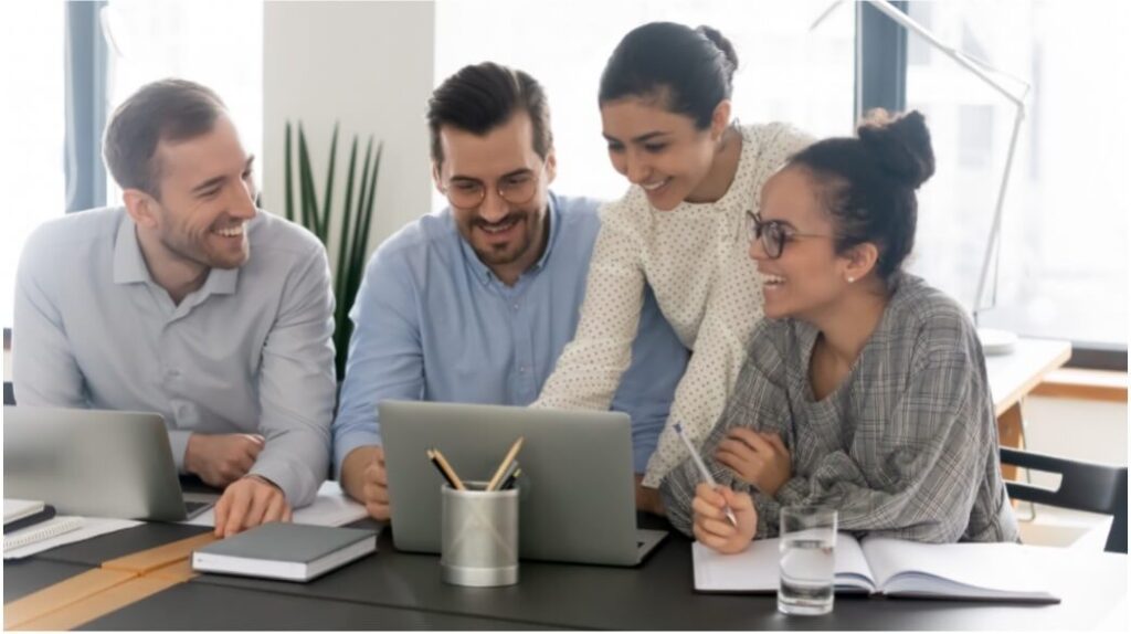 Four people at work with desk sharing